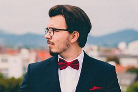 A man in a suit and bow tie.
