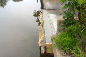 A dock with a concrete slab on the side of it.