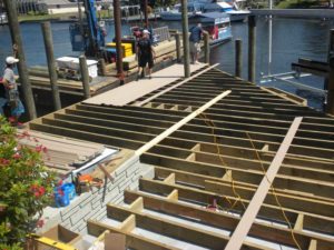 A dock being built with many wooden planks.