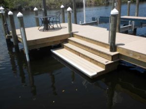 A dock with steps and stairs leading to the water.