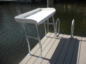 A boat dock with a table on the side of it.