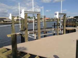 A dock with several white flags on it.